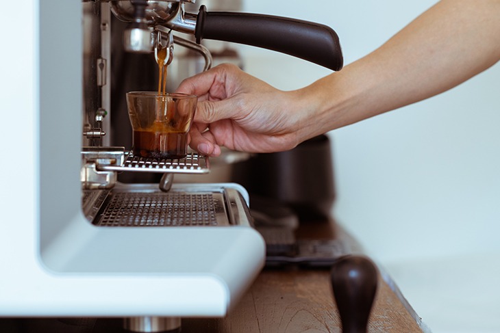 hand making coffee on barista machine